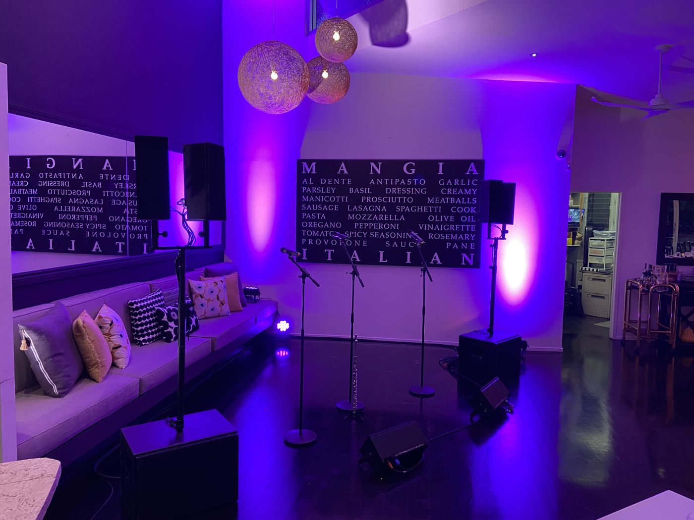 Slim speakers and uplighting on a dinner-show stage